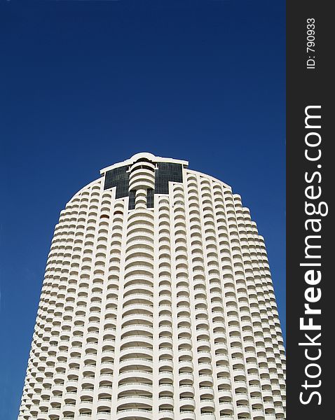 Tall, circular apartment building with many balconies. Tall, circular apartment building with many balconies