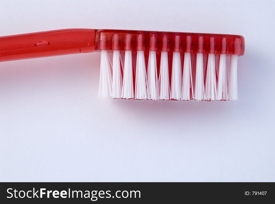Close-up of red toothbrush against white background