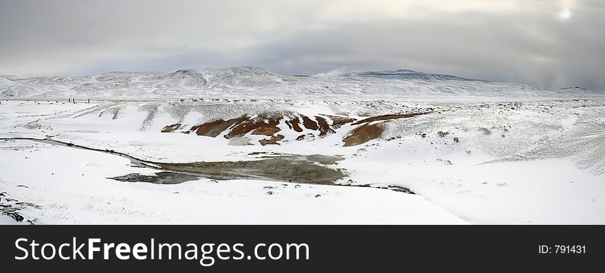 Hot Springs thrusting through a bleak Wintery Icelandic snowscape. Hot Springs thrusting through a bleak Wintery Icelandic snowscape