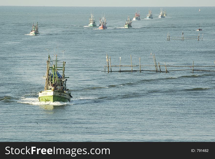 Every morning Thai fishermans control their ship back to the piers. Every morning Thai fishermans control their ship back to the piers.