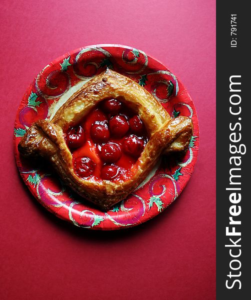 Cherry pastry on a Christmas plate. Cherry pastry on a Christmas plate