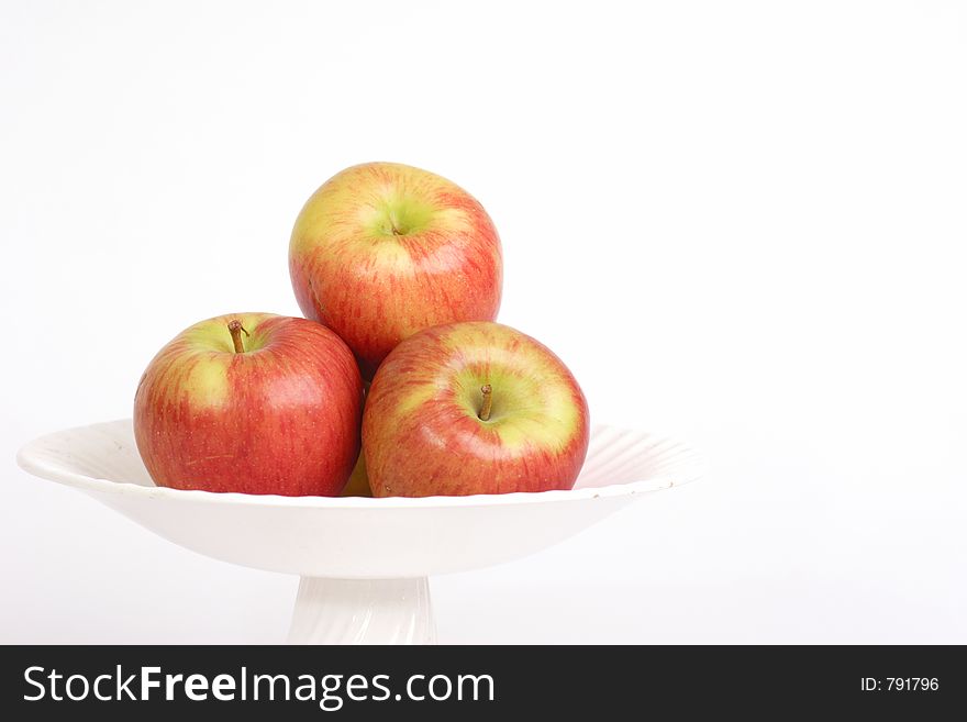 Three apples in a bowl