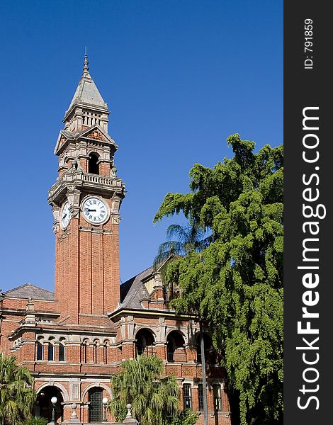 Church clock against blue sky