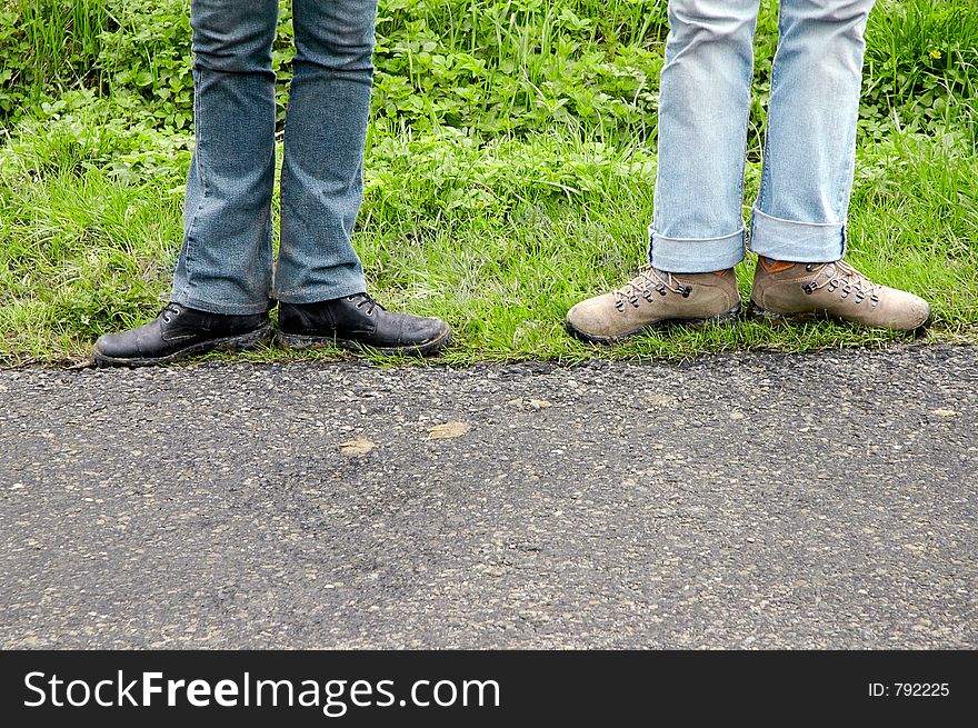 Two pairs of legs over tourist track, in funny pose. Free space below prepared for inscriptions. Two pairs of legs over tourist track, in funny pose. Free space below prepared for inscriptions.