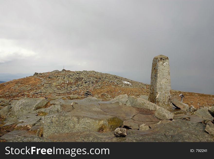 Peak of the rocky mountain in cloudy day, stone pillar. Peak of the rocky mountain in cloudy day, stone pillar.