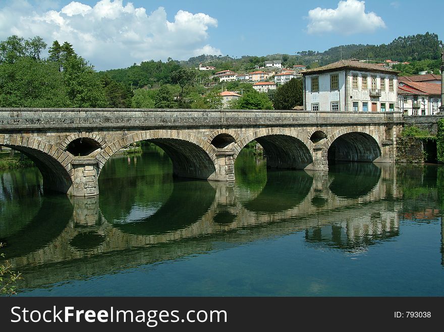 Roman bridge and river on village
