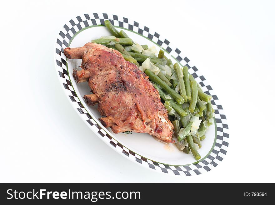 Baked ribs with green beans on a plate