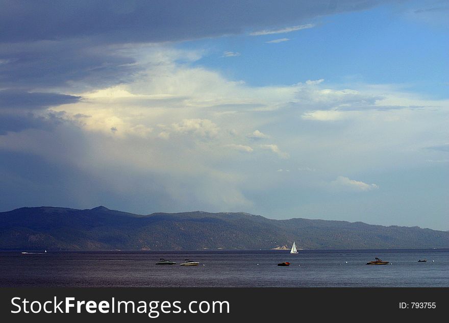 Lake filled with boats and a cloudy sky. Lake filled with boats and a cloudy sky.