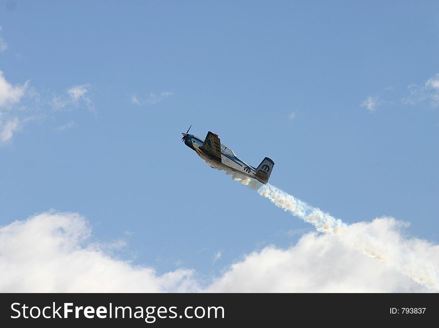 Plane flying through the clouds with smoke. Plane flying through the clouds with smoke.