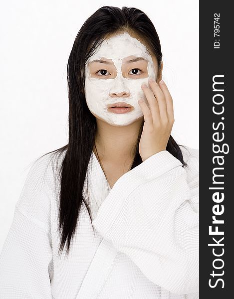 A young teen with a white face pack on