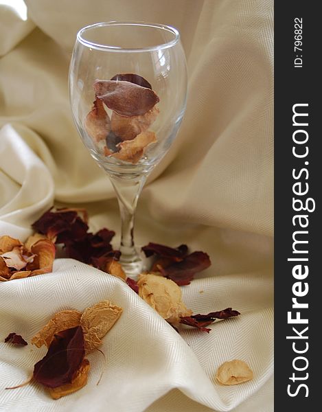 Dried rose petals in a wine glass. Dried rose petals in a wine glass