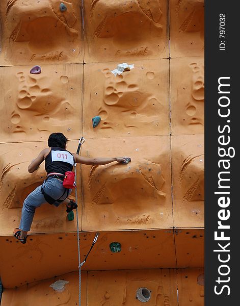 Lady climber in a competition. Lady climber in a competition