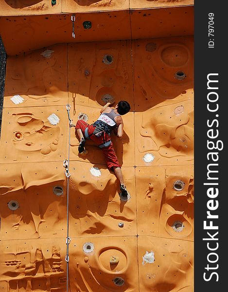 Lady climber in a competition. Lady climber in a competition