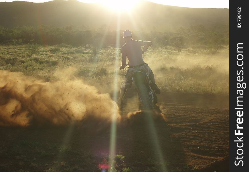 Man on a motorbike with sunset. Man on a motorbike with sunset