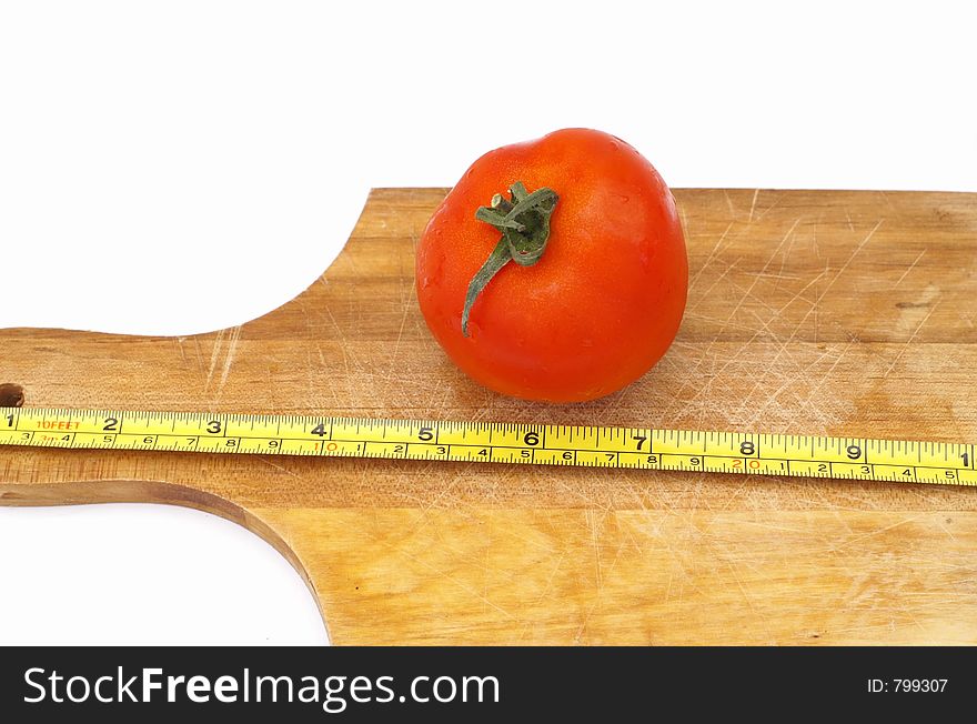 Measuring a tomato on a cooking plate