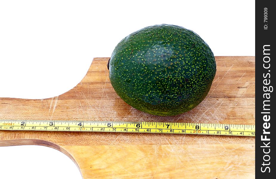 Measuring an avocado on a cooking board