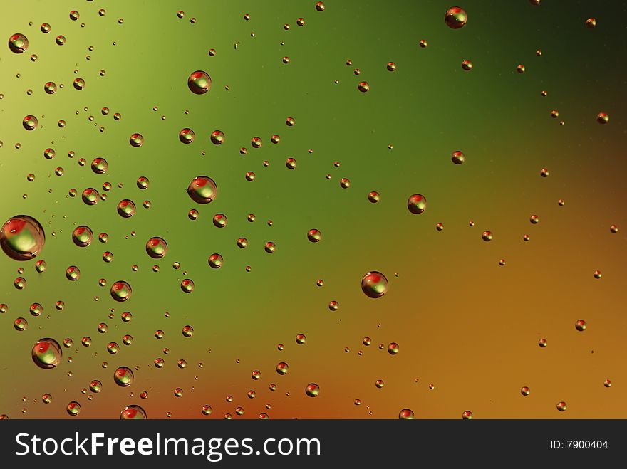 Clean waterdrops on green - red background. Clean waterdrops on green - red background