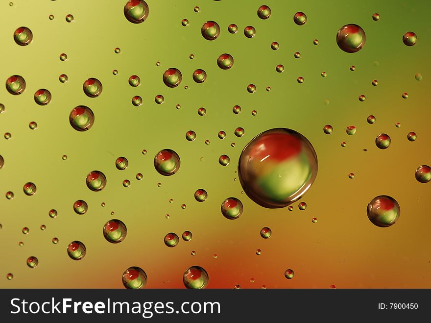 Clean waterdrops on green - red background. Clean waterdrops on green - red background