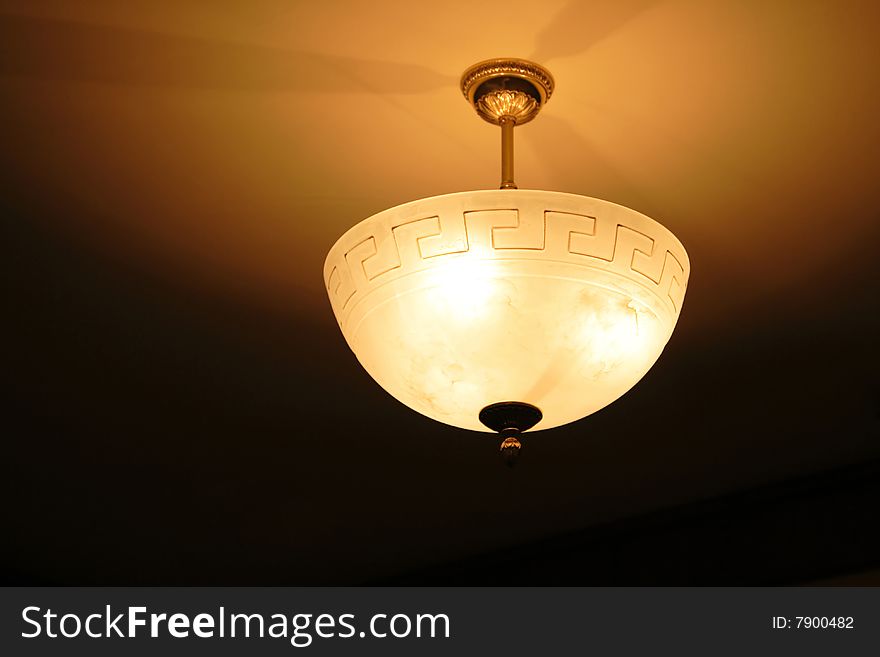 Classic chandelier in the hotel, ceiling lamp in the room