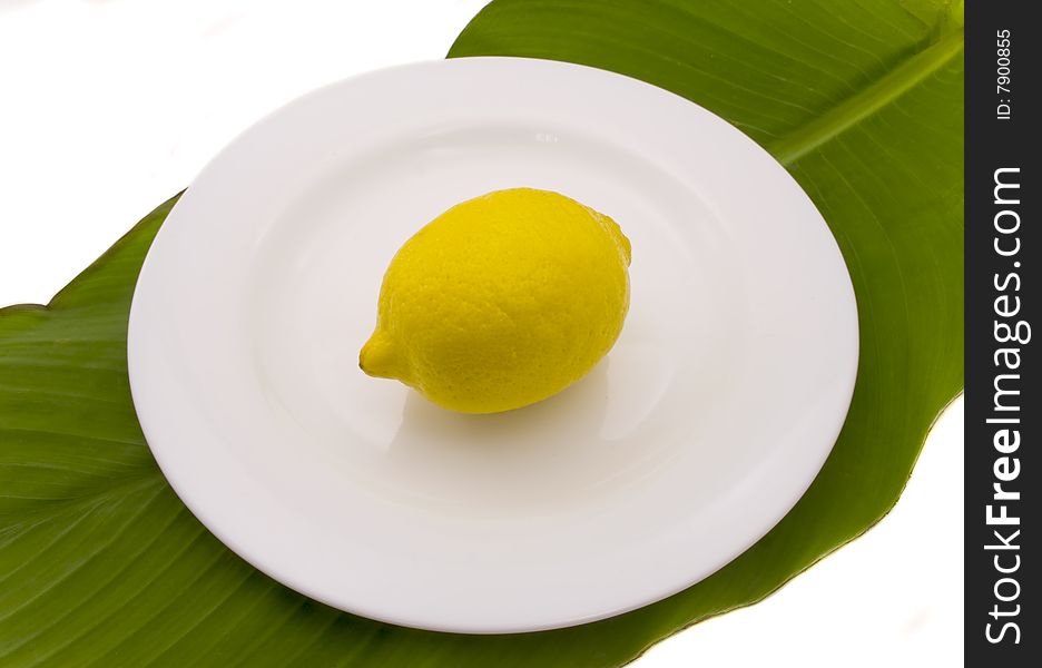 Lemon  on a white plate the isolated on a white background