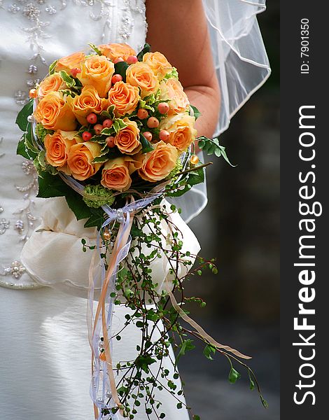 Bride Holds A Beautiful Bouquet Of Roses