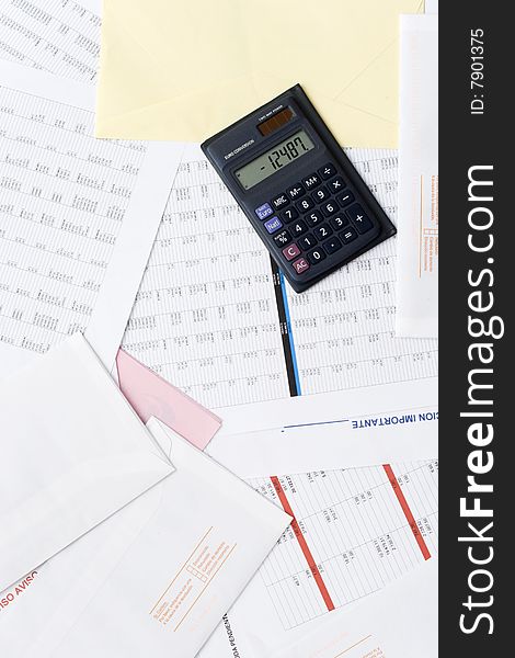 A calculator on top of financial reports. A calculator on top of financial reports.