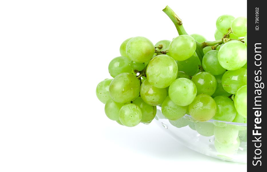 Green grapes in bowl on white background