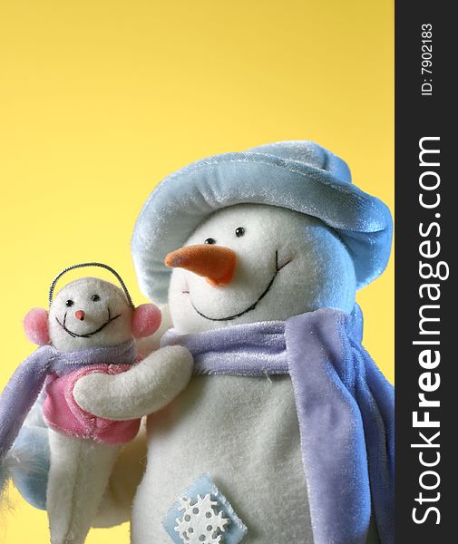 Snowman with his little baby on yellow background