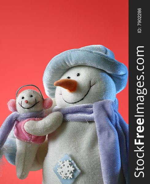 Snowmen with his baby on the red background