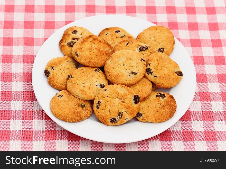 Plate of chocolate chip cookies on checked tablecloth. Plate of chocolate chip cookies on checked tablecloth