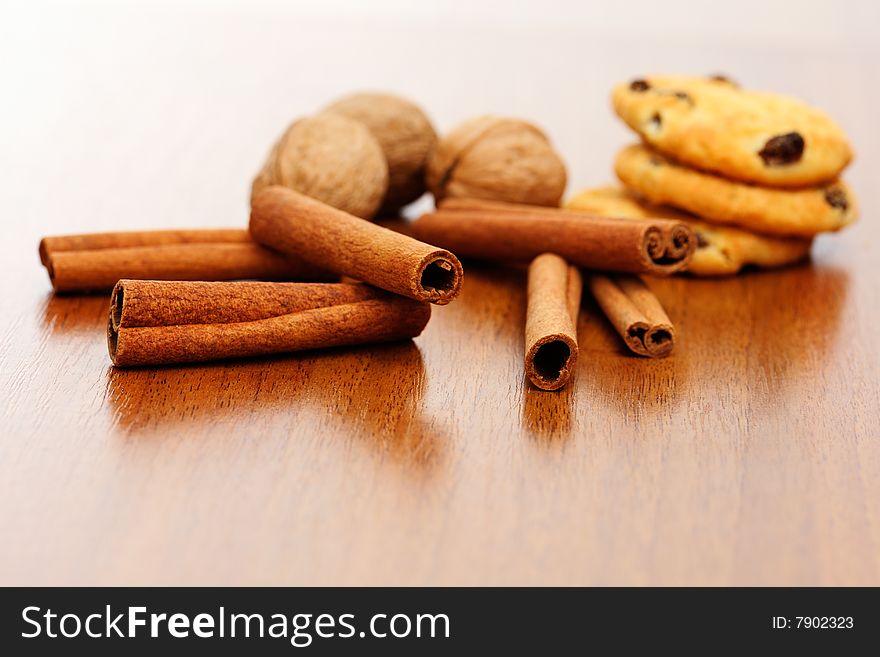 Cinnamon, circassian walnut and cookies on the table background. Cinnamon, circassian walnut and cookies on the table background.