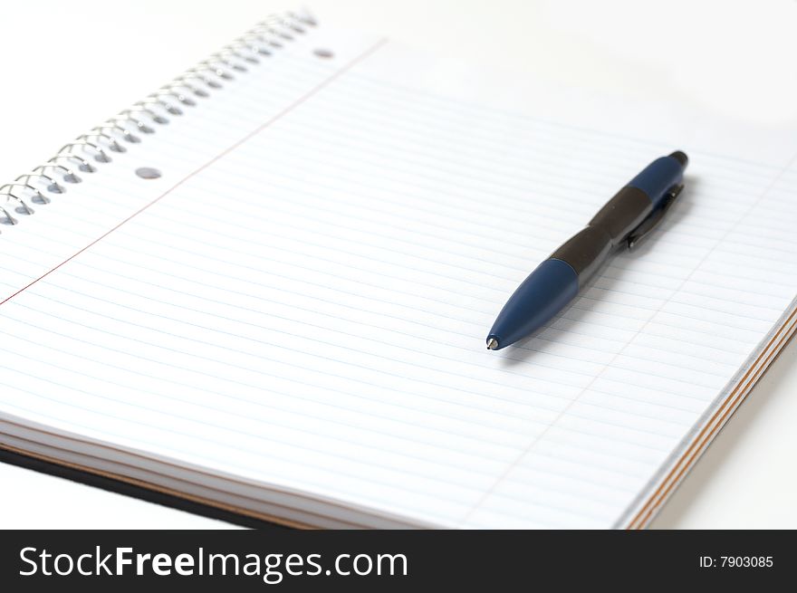 A macro picture of a pen and notebook. A macro picture of a pen and notebook