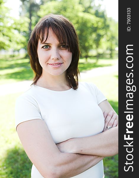 Close-up portrait of a young woman during her walk in a park. Close-up portrait of a young woman during her walk in a park