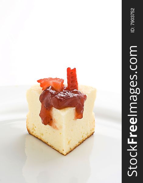 Cheesecake with fresh strawberries and blackberry jam isolated over white