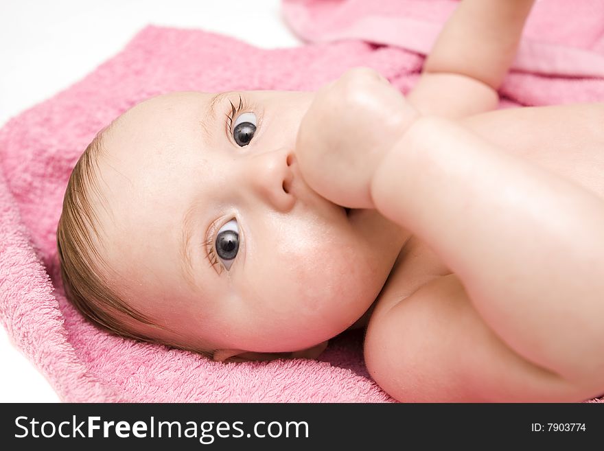 Little baby after bath on white