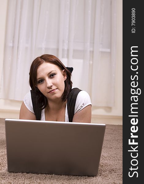 Woman with laptop on carpet