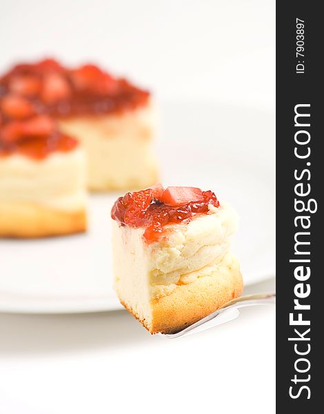 Cheesecake with fresh strawberries and blackberry jam isolated over white