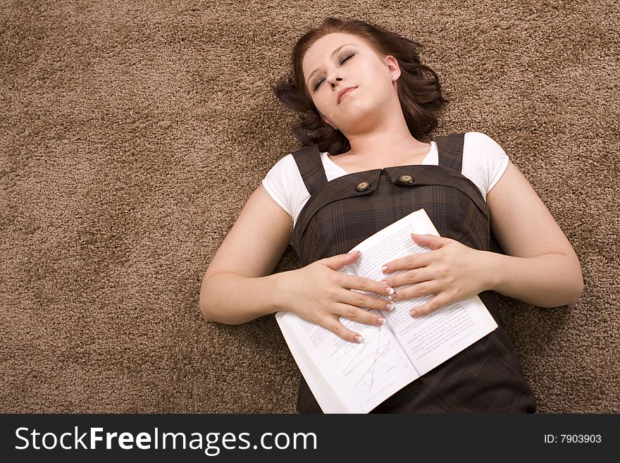 Woman reading a book on carpet. Woman reading a book on carpet