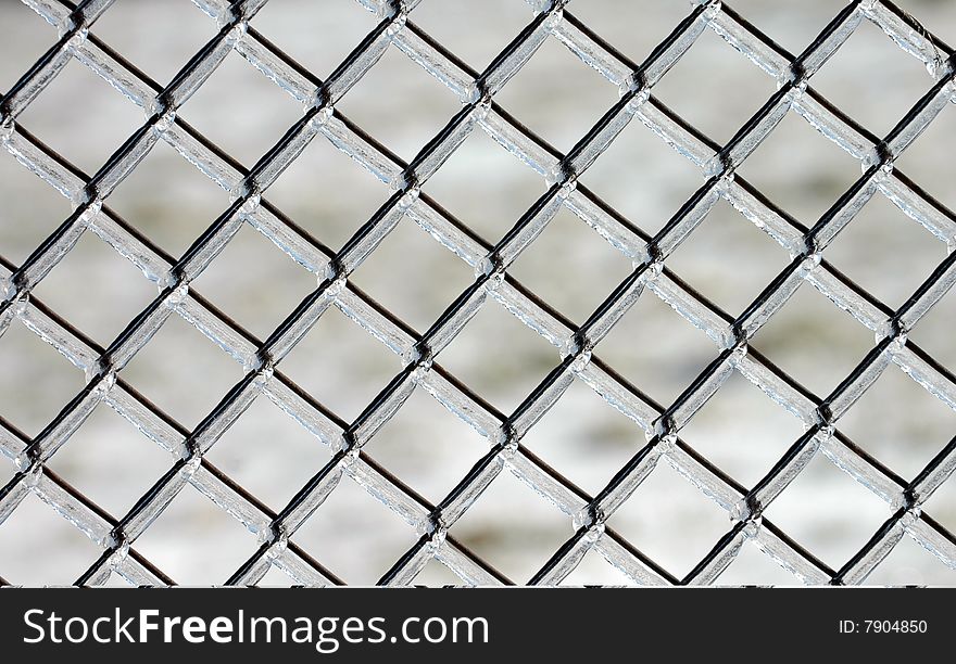 A grid of ice and wire on a cold winter day. A grid of ice and wire on a cold winter day.