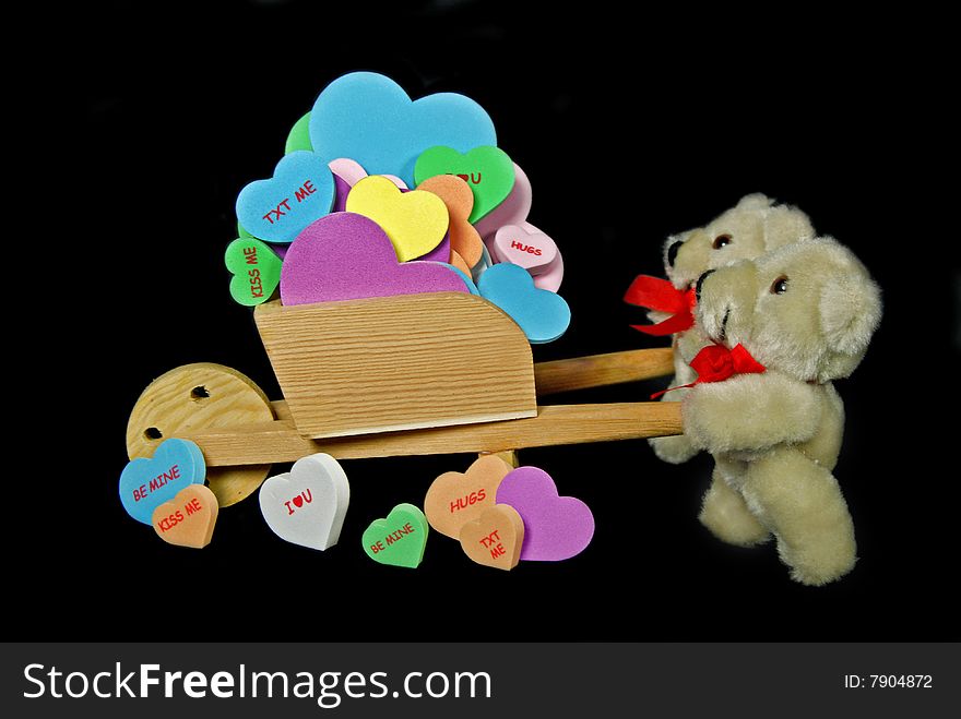 Teddy bears pushing a cart full of hearts. Teddy bears pushing a cart full of hearts.