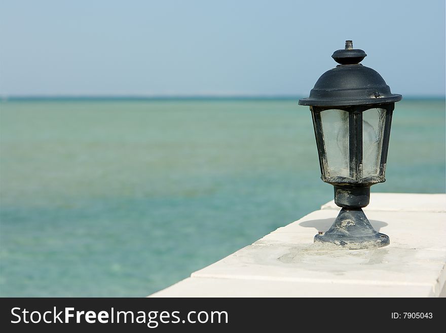 Lamp and sea on background