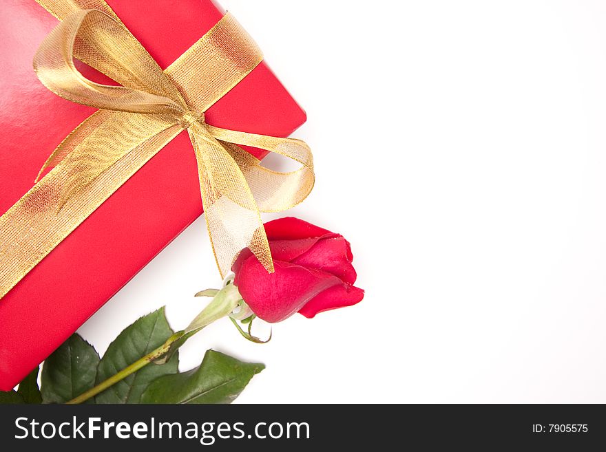 Gift with Gold Ribbon and Rose on White