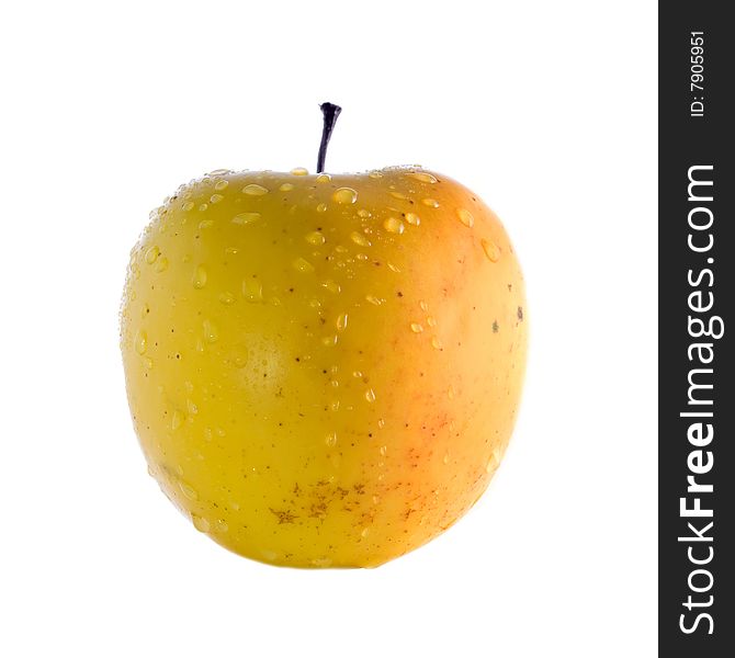 Stock photo: an image of a big yellow apple with drops of water on it