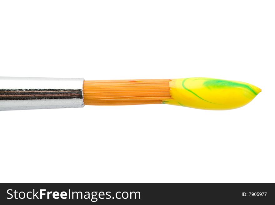 Stock photo: an image of a brush with yellow paint on it