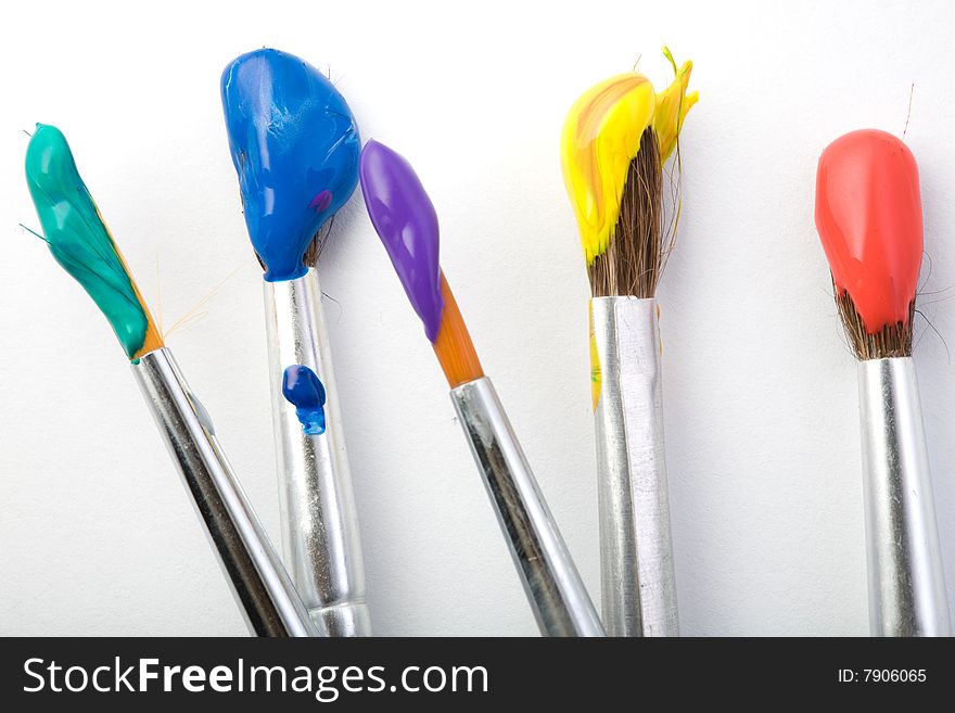 Stock photo: an image of a set of paintbrushes with paints on them