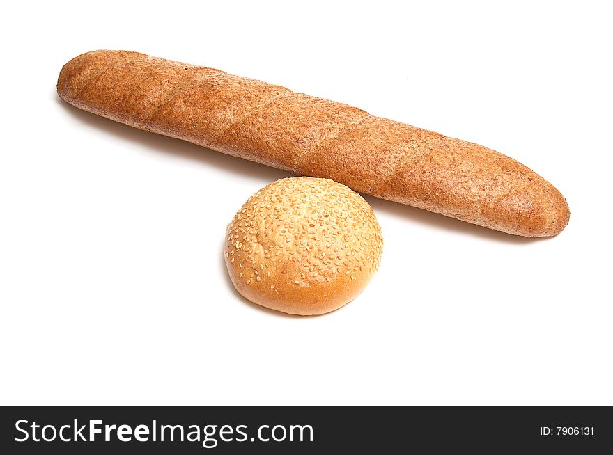 Long loaf and bun isolated on a white background. Long loaf and bun isolated on a white background.