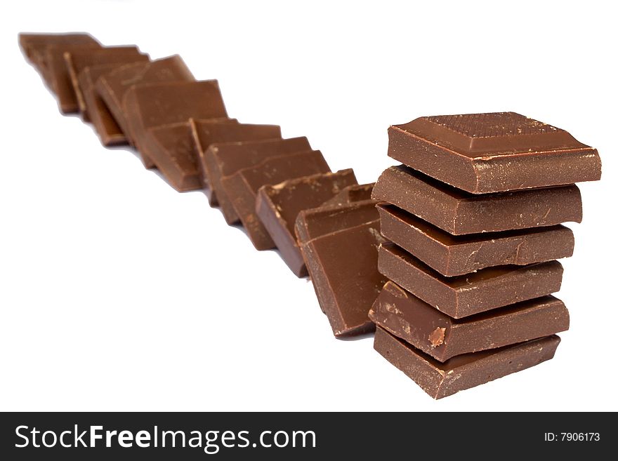 Tower and line of chocolate fragments on a white background it is isolated