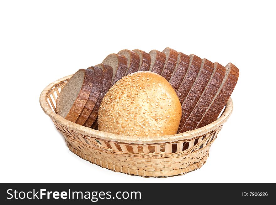 Bread and bun in the braided basket isolated on a white background. Bread and bun in the braided basket isolated on a white background.