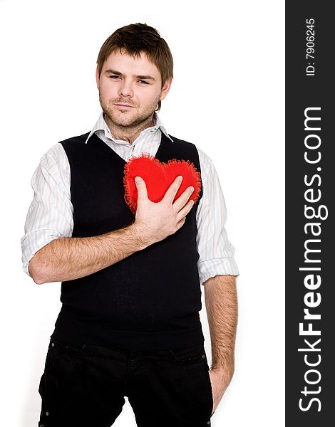 Stock photo: an image of a man pressing a red heart to his chest. Stock photo: an image of a man pressing a red heart to his chest