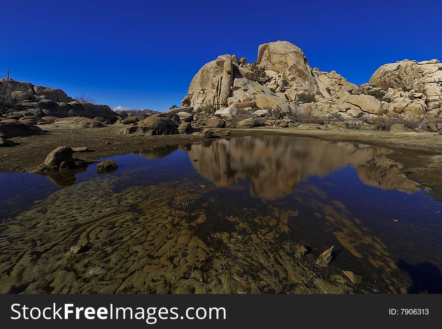 A mirror lake found at barker's dam in Joshua Tree Natural park in southern california. A mirror lake found at barker's dam in Joshua Tree Natural park in southern california